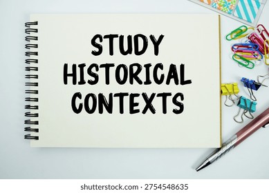 Study Historical Contexts text message written on notepad with stationery flat lay on white background