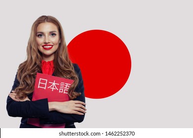 Study Japanese Language. Pretty Brunette Girl Student With Japan Flag. Book With Inscription Japan On Japan Language