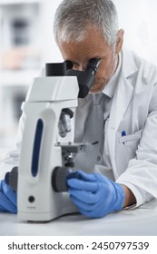 Study, mature man and microscope in lab for discovery, medical research and test for forensics. Male person, control and doctor for biology or pathology exam, lens and check results of experiment