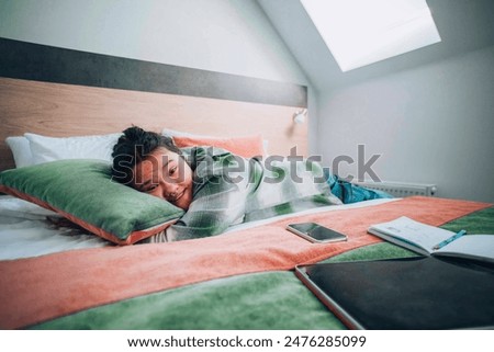 study overload, featuring a student who has collapsed into sleep
