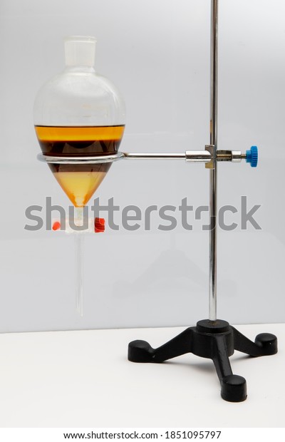The study Separating by filtration the component\
substances from liquid mixture in Lab. Separating natural product\
use dichloromethane with water have two layer blue and yellow in\
separating funnel.