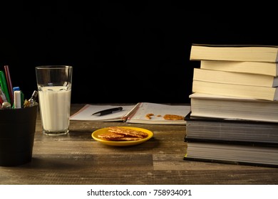 study table desk with books a open sketch book and pencil bucket, university study, school.