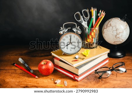 Study workspace with textbooks and globe, educational achievement concept