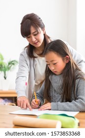 Studying Child And Parents Watching Study