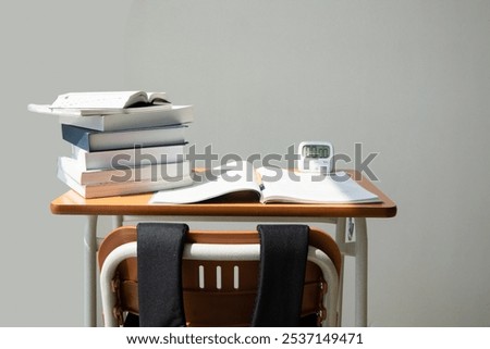 studying at home, study desk setup_stack of workbooks