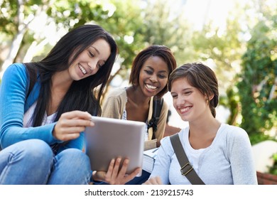Studying Is So Much More Fun With Your Friends. Shot Of A Diverse Group Of College Students Sitting Together Outside Doing Online Research.