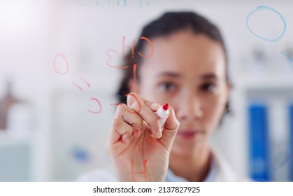 Studying New Scientific Matter. Shot Young Scientist Drawing Molecular Structures On A Glass Wall In A Lab.