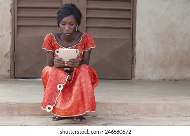 Studying Symbol: African Ethnicity Girl Reading Tablet Computer Laptop Mali IPad