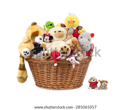 Stuffed animal toys in a basket, isolated on a white background