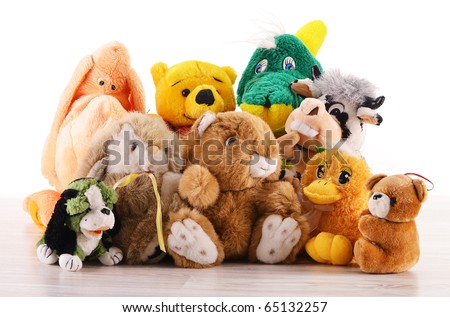 Stuffed animal toys on the wooden floor isolated on white