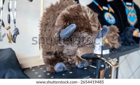 A stuffed bison on display on a shelf at a store