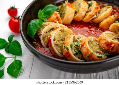 Stuffed calamari. Squid stuffed with rice and vegetables in tomato sauce, cooked in tomato and wine sauce