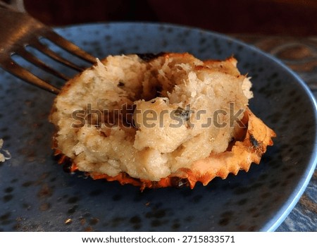 Stuffed crab shell on ceramic plate photography