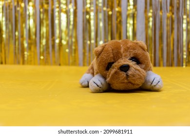 Stuffed Dog Toy On A Golden Background