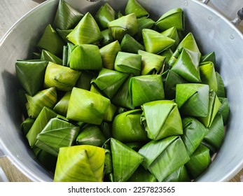 stuffed dough pyramid or dough wrapped in banana leaves for chinese new year celebrations. chinese new year food. Traditional Thai Dessert wrapped. - Shutterstock ID 2257823565