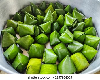 stuffed dough pyramid or dough wrapped in banana leaves for chinese new year celebrations. chinese new year food. Traditional Thai Dessert wrapped. - Shutterstock ID 2257984005