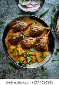 Stuffed Eggplant Or Brinjal Curry In Bowl With Onions And Chilies On Concrete Surface - Indian Food