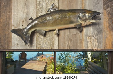 Stuffed Fish Mounted On The Wall With Deck And Lake In The Background