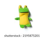 stuffed frog made of cloth lying on a white background