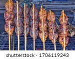
Stuffed frog meat stuffed on skewers grilled on a stove arranged