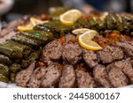 Stuffed grape leaves of the grapevine plant stuffed with a mixture of rice, meat, and spices. Traditional Turkish Dolma details, Sarma or Dolmades on open buffed. Turkish appetizer varieties
