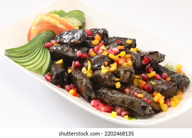 Stuffed Grape Leaves, Lemon, Tomatoes And Pomegranate Seeds, Stuffed. Traditional Stuffed Paper Wrap. White Background.