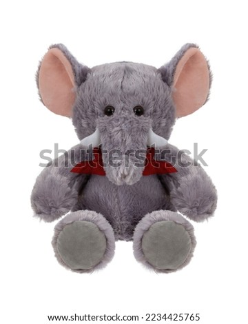 Stuffed gray elephant with red bow sitting on white background
