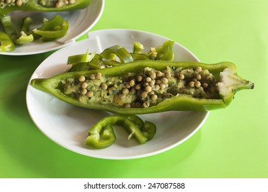 Stuffed Green Pepper On A Plate On Green Background