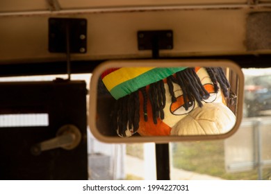 Stuffed Monkey Toy Looking Off In Car Mirror