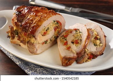 Stuffed Pork Roast On White Platter.