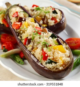 Stuffed Roasted Aubergines, Brinjal Or Eggplant With A Savory Quinoa And Veggie Filling Served On A Plate For Vegetarian Cuisine