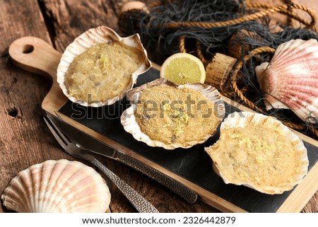 Stuffed scallops on rustic wooden table with an old fishing net