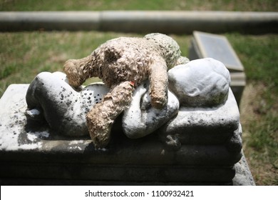 Stuffed Teddy Bear Lying On Top Of A Child's Grave Baby Marble Statue Grave Memorial Marker