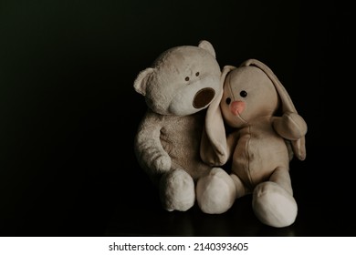 Stuffed toys brown teddy bear hugs bunny.