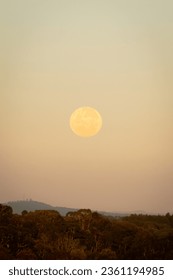 stuning beatiful full moon on dusk with mountains far away