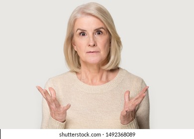 Stunned Caucasian Senior Woman Isolated On Grey Studio Background Feel Surprised By Deal Or Promotion, Amazed Aged Female Look At Camera Shocked By Unexpected Unbelievable Sale Offer