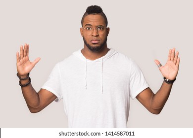 Stunned funny black 30s man in glasses gawp at camera stretched hands showing something huge feels shocked pose isolated on grey studio background, large big size gesture of exaggerating concept image