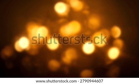 A stunning abstract background featuring warm golden bokeh lights, perfect for various creative projects. The blurred lights create a soft, dreamy atmosphere.