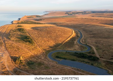 Stunning Aerial Drone Landscape Image Of Golden Hour Over Farmers Fields In South Downs National Park In England During Summer Dawn