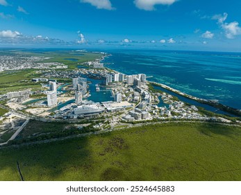 Stunning aerial drone view of Puerto Cancún, Mexico, showcasing luxury yachts, waterfront properties, and the vibrant Caribbean coastline