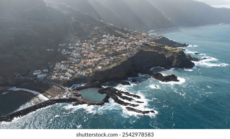 A stunning aerial perspective of a picturesque coastal village perched on cliffs by the ocean, showcasing the harmony between natural beauty and human settlement. - Powered by Shutterstock