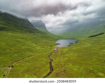 Stunning aerial perspective showcasing the tranquil lake nestled among vibrant green hills and mountains in the breathtaking Scottish Highlands near Applecross. - Powered by Shutterstock