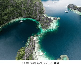 Stunning aerial shot of a tranquil lagoon surrounded by towering limestone cliffs, with boats anchored in turquoise waters in Coron, Palawan, Philippines - Powered by Shutterstock