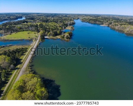 stunning aerial shot of the vast blue waters of Lake Horton surrounded by lush green trees and a gorgeous clear blue sky on a winter day in Fayetteville Georgia USA
