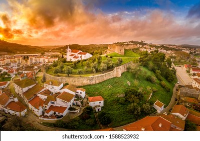 Stunning aerial sunset panorama of the medieval castle with Moorish origins in Torres Vedras Portugal with restored castle church and keep