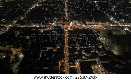 Stunning aerial view or drone shot of Charminar, Hyderabad at night. The vibrant city lights illuminate the bustling market below. Perfect for travel and cityscape themes.