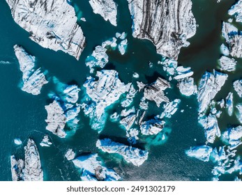 Stunning aerial view of a glacial lagoon in Iceland, showcasing deep blue waters and variously sized icebergs. A unique display of nature's beauty and power. - Powered by Shutterstock