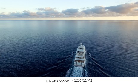 A Stunning Aerial View Of Large Super Yacht Underway On The Sunset