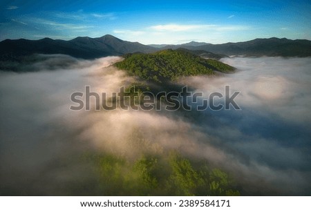 A stunning aerial view of a mountainous landscape shrouded in fog