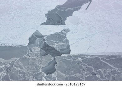 A stunning aerial view of a snowcovered mountain range with a glacier carving its way through the landscape. The frozen terrain and vast expanse of ice c. Elements of this image furnished by NASA - Powered by Shutterstock